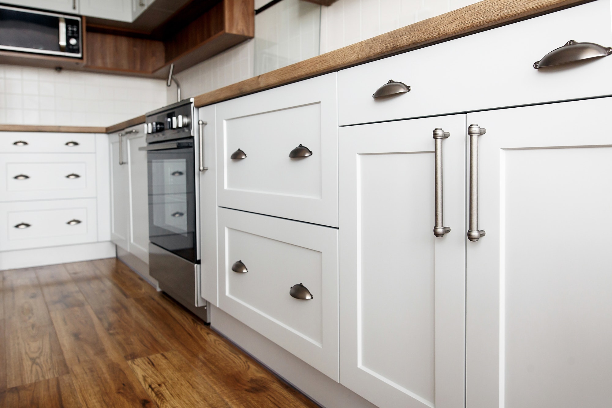 white kitchen cabinets with flat doors